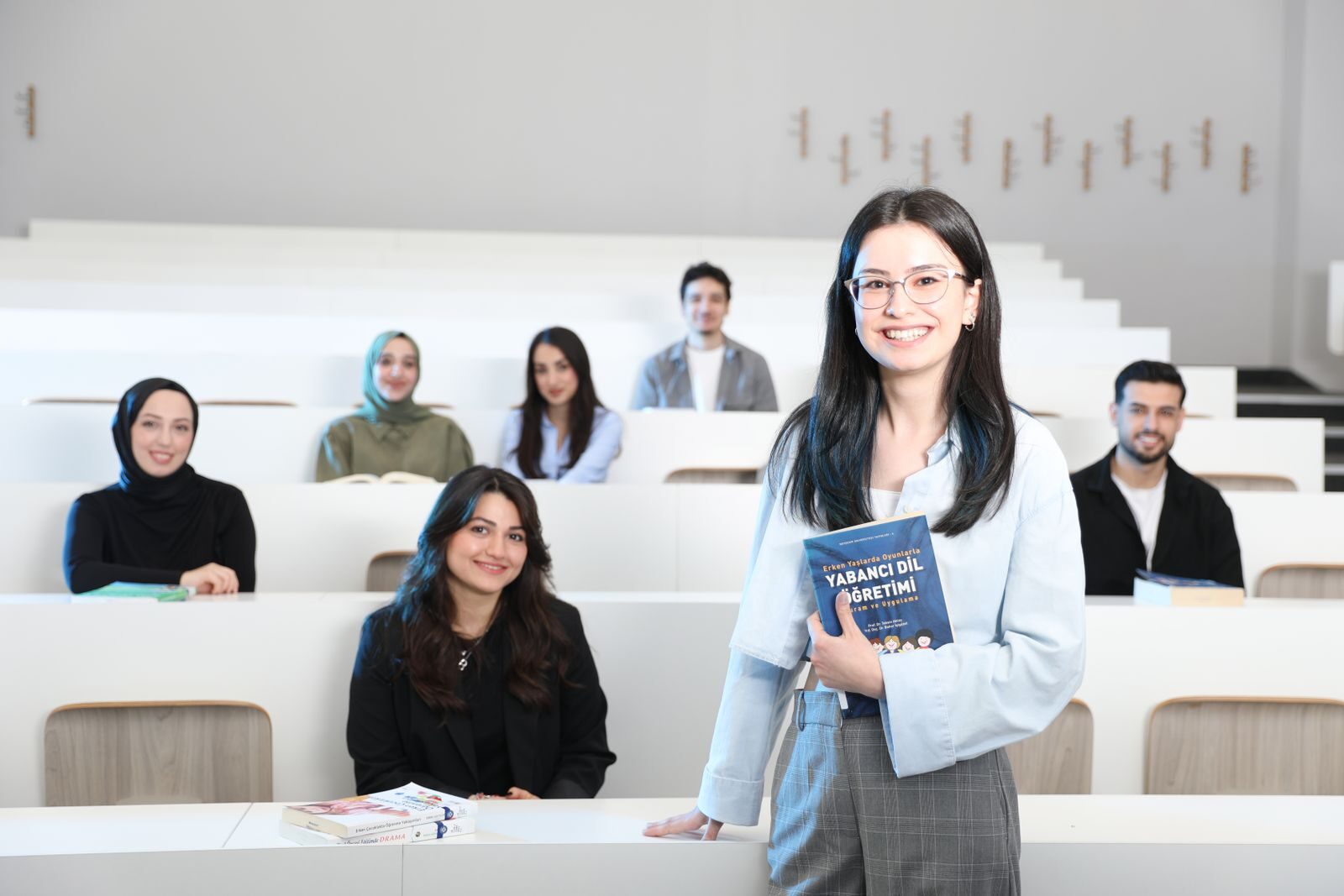 Group of diverse university students in a bright lecture hall, studying language education.